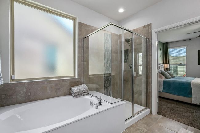 Full bathroom featuring a bath, a stall shower, and ensuite bath | Image 13