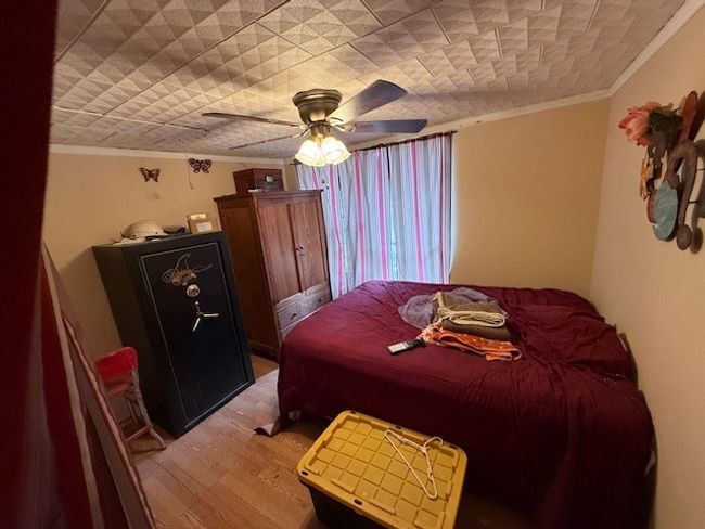 Bedroom featuring ornamental molding, wood-style floors, and ceiling fan | Image 38