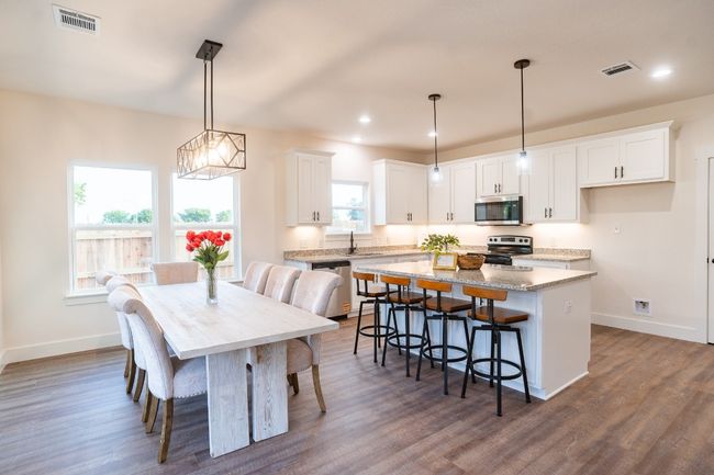 Dining space featuring baseboards, healthy amount of natural light, dark wood finished floors, and recessed lighting | Image 7