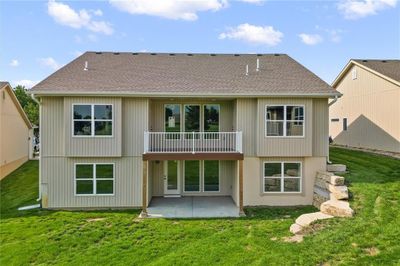 Rear view of house featuring a patio, a balcony, and a yard | Image 2