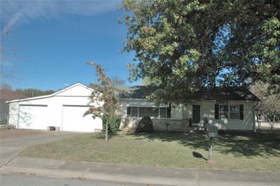 Single story home featuring a front lawn and a garage | Image 2