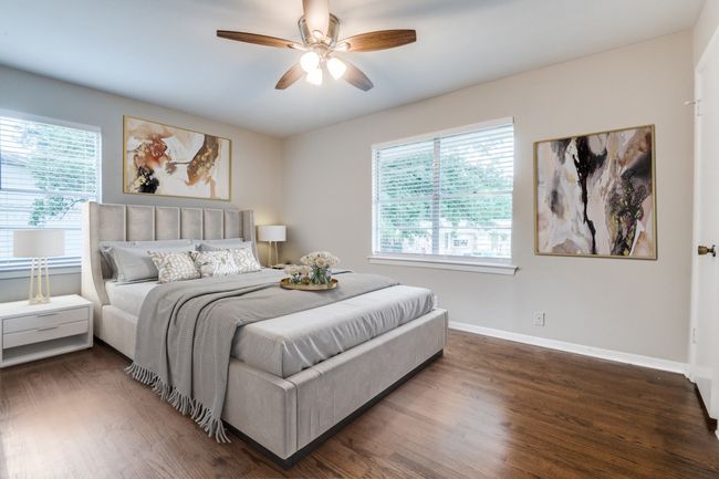 Virtual staged Bedroom with wood finished floors, multiple windows, and baseboards | Image 15
