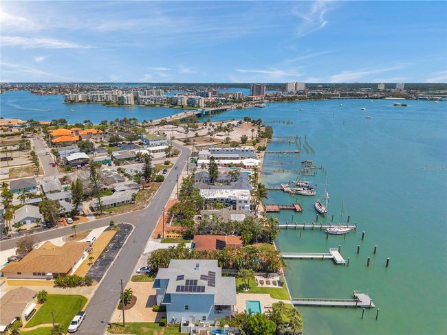 Aerial view showcasing the neighborhood of this luxury waterfront home. | Image 82