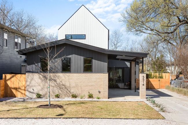 View of front facade featuring a gate, fence, and brick siding | Image 37