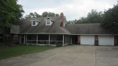 View of front of home. Wrap around screened porch! | Image 2