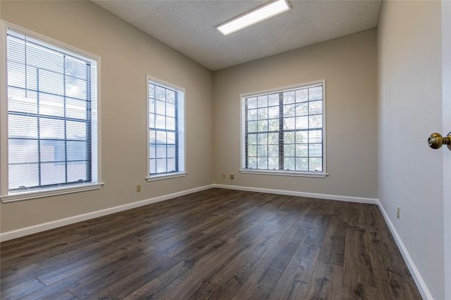 Empty room featuring dark wood-style flooring and baseboards | Image 4