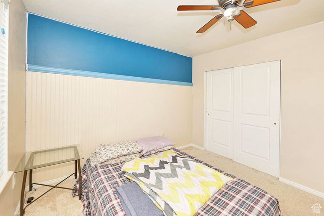 Bedroom featuring a closet, ceiling fan, carpet, and baseboards | Image 27