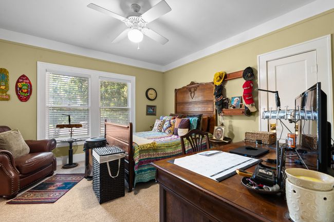 Bedroom with light carpet and ceiling fan | Image 19