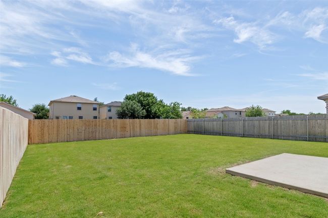 View of yard featuring a patio area and a residential view | Image 31
