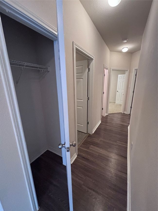 Corridor featuring dark wood-style floors and baseboards | Image 7