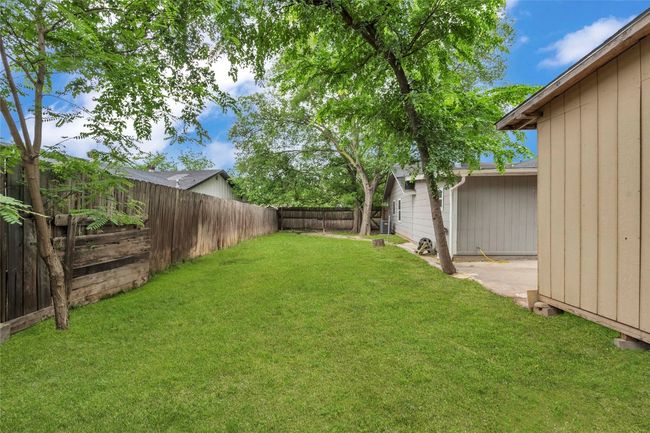 View of yard with a fenced backyard | Image 6