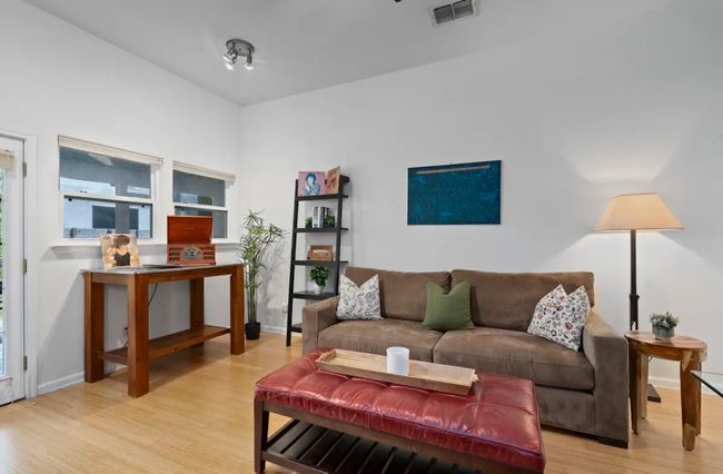 Living area featuring light wood-style floors and baseboards | Image 5