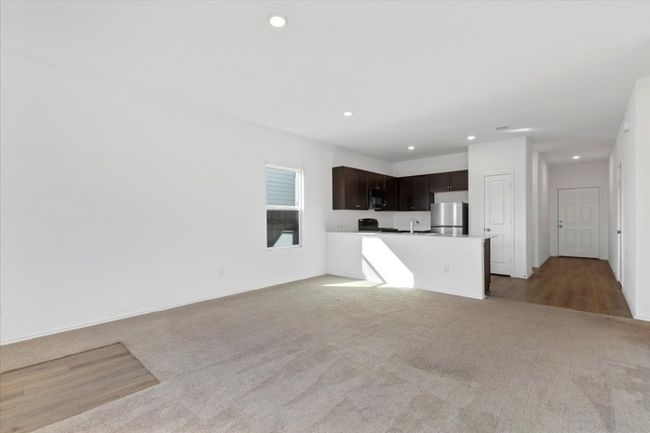 Unfurnished living room featuring carpet flooring and recessed lighting | Image 9