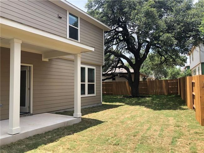 Fenced backyard with a patio area | Image 25