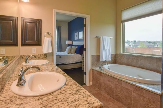 Ensuite bathroom with double vanity, a sink, ensuite bathroom, and a garden tub | Image 17