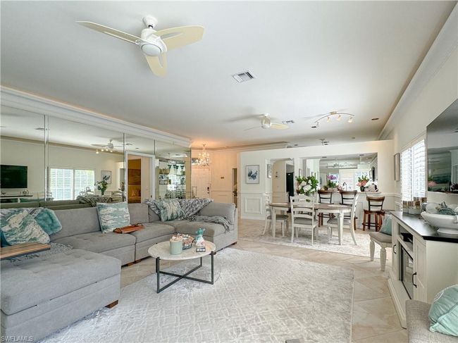 Living room with plenty of natural light, ceiling fan, crown molding, and light tile floors | Image 31