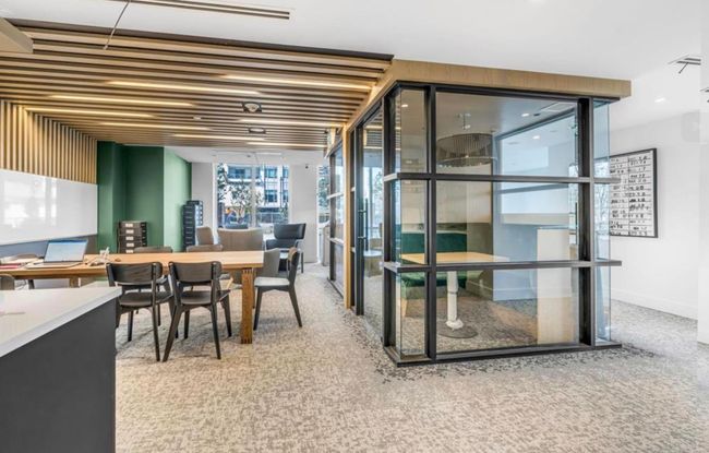 Carpeted dining space featuring expansive windows and baseboards | Image 15
