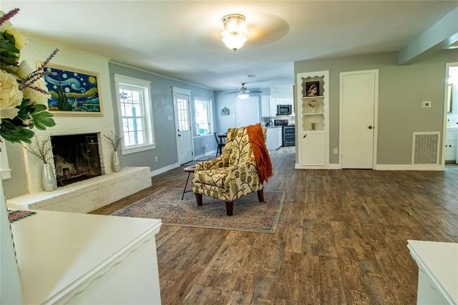 View from the primary bedroom door toward the den and breakfast room beyond. | Image 11