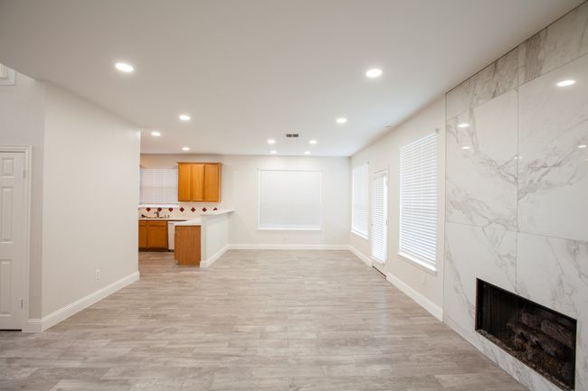 Unfurnished living room featuring recessed lighting, light wood-style floors, and a fireplace | Image 19