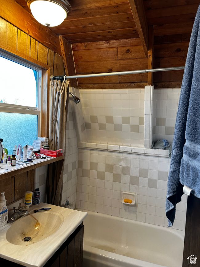 Bathroom with wood ceiling, shower / bath combo, and vanity | Image 4