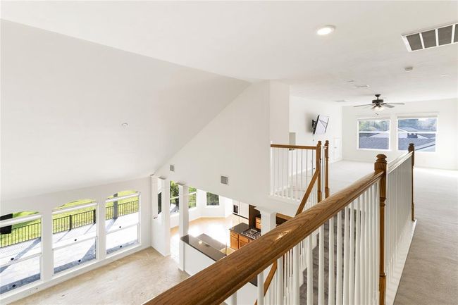 The second floor features open views overlooking the living space below, creating a spacious and connected feel throughout the home. | Image 25