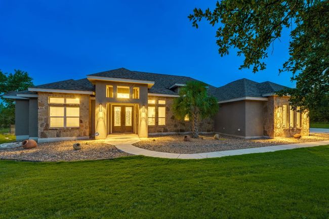 Prairie-style house with stone siding, a front yard, and french doors | Image 10