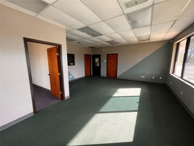 Spare room featuring dark colored carpet, visible vents, a drop ceiling, and​​‌​​​​‌​​‌‌​‌‌​​​‌‌​​‌‌​‌​​​​​‌ baseboards | Image 16