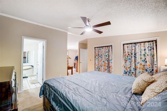 The primary bedroom features an ensuite full bathroom. | Image 20