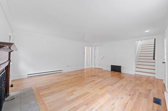 The living room has a wood-burning fireplace. | Image 14