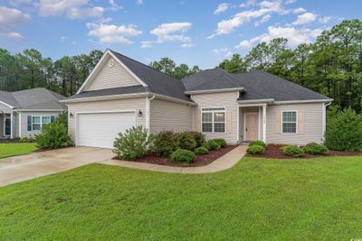 Single story home featuring a garage and a front lawn | Image 1