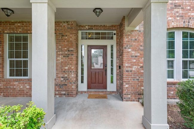 Entrance to property with brick siding and covered porch | Image 4