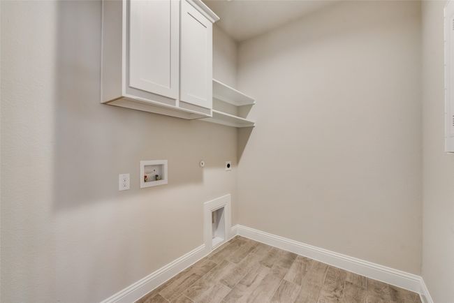 Washroom featuring cabinets, light hardwood / wood-style flooring, hookup for a washing machine, hookup for an electric dryer | Image 12