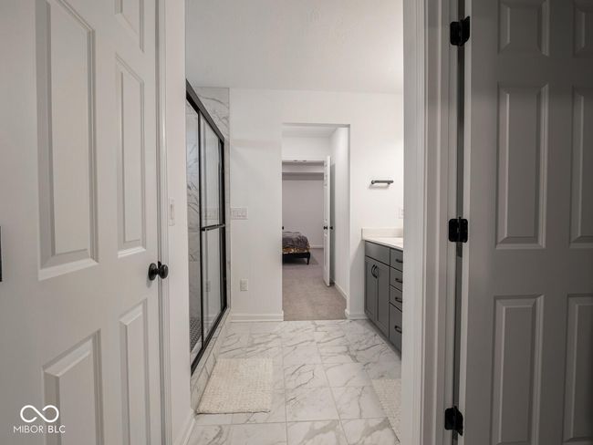 ensuite bathroom featuring a stall shower, marble finish floor, ensuite bathroom, and vanity | Image 39