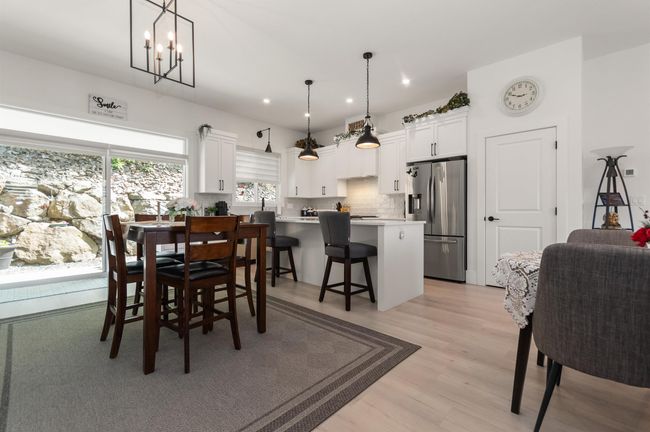 Dining space featuring recessed lighting, light wood finished floors, and a chandelier | Image 9