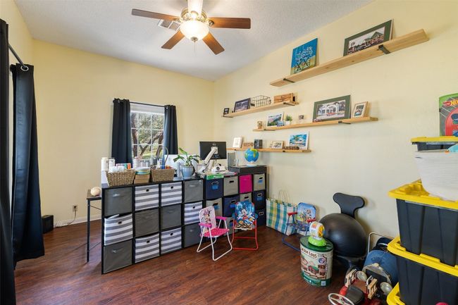 Office with wood finished floors and ceiling fan | Image 26
