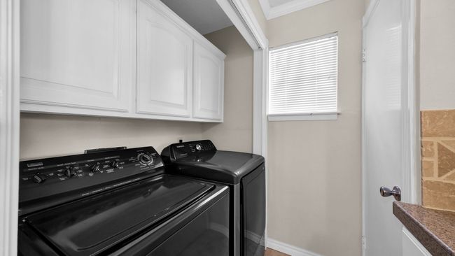 Laundry room featuring crown molding, cabinets, and independent washer and dryer | Image 16