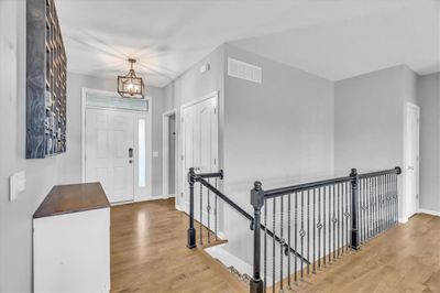 Foyer with hardwood / wood-style floors and a chandelier | Image 2