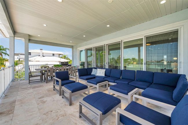 Huge covered 2nd story balcony with travertine tile. | Image 20