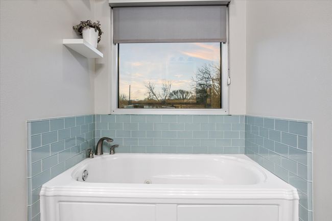 Bathroom featuring a bath | Image 9