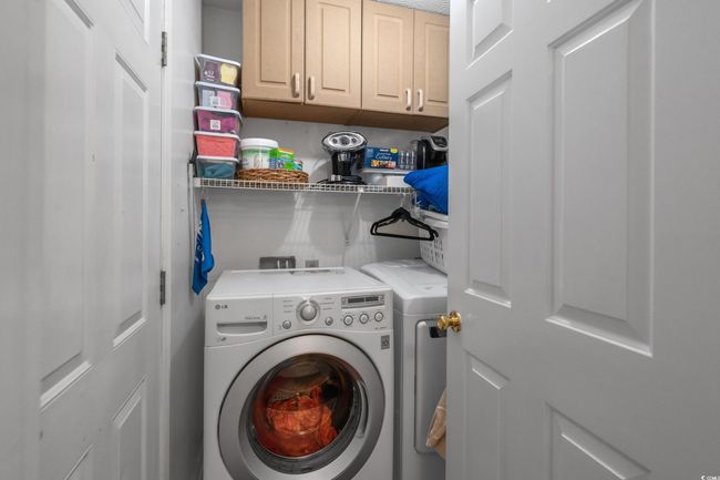 Laundry area featuring independent washer and dryer and cabinet space | Image 23