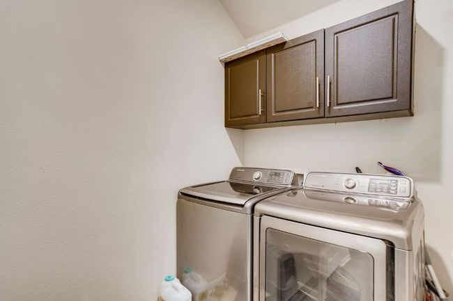 Laundry area featuring washer and dryer and cabinet space | Image 23