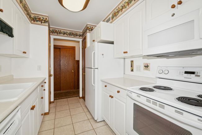 Bright, clean and convenient kitchen with pantry and utility closet | Image 11