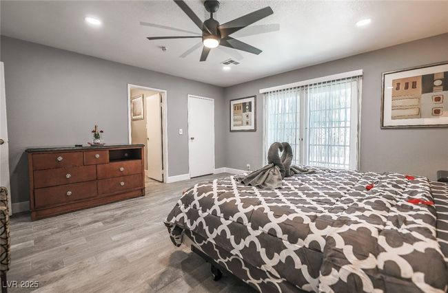 Bedroom with light wood-style floors, baseboards, a ceiling fan, and recessed lighting | Image 44