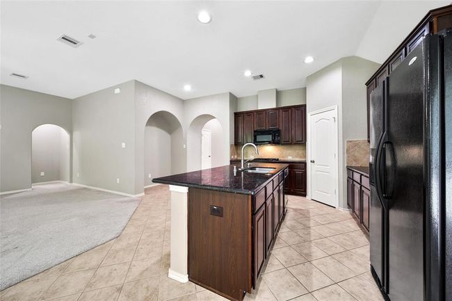 The gas cooktop and walk-in pantry are sure to please the family chef. | Image 12