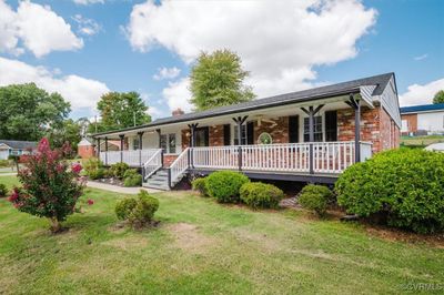 View of front of house featuring a front yard and covered porch | Image 1