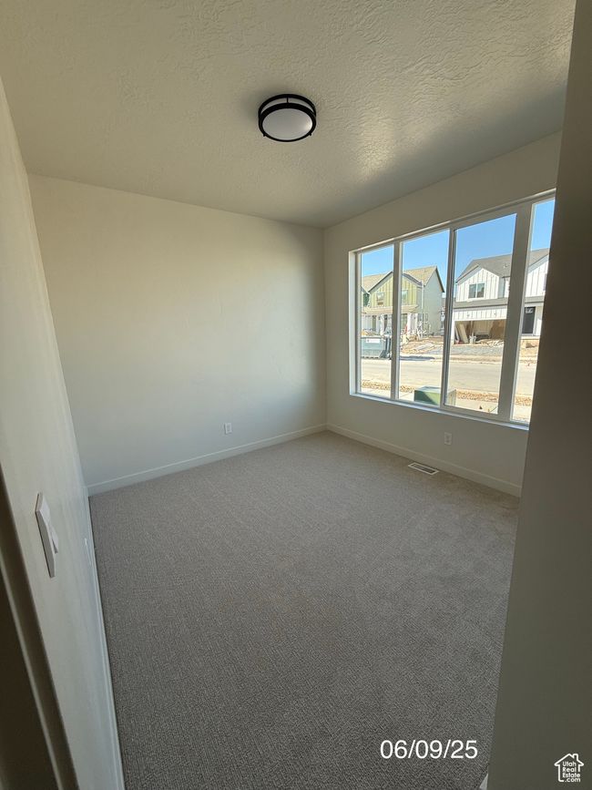 Spare room with carpet flooring, baseboards, and a textured ceiling | Image 11