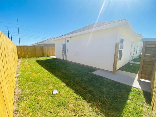 View of fenced backyard | Image 15
