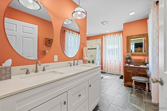 Ensuite bath adjacent to primary bedroom on 1st floor with a double vanity, and a walk in, zero entry large shower. | Image 20