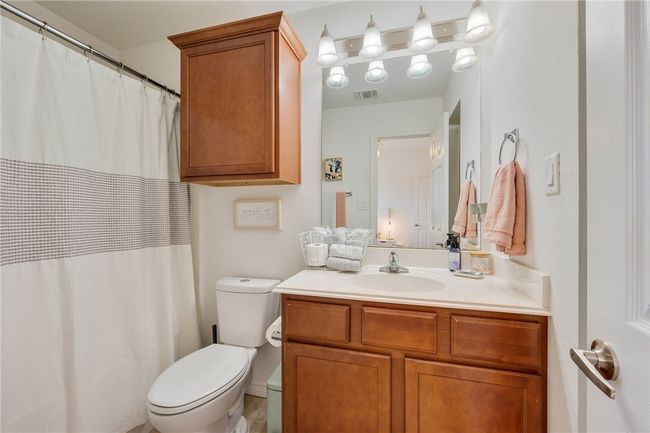 Bathroom with vanity and a shower with curtain | Image 16