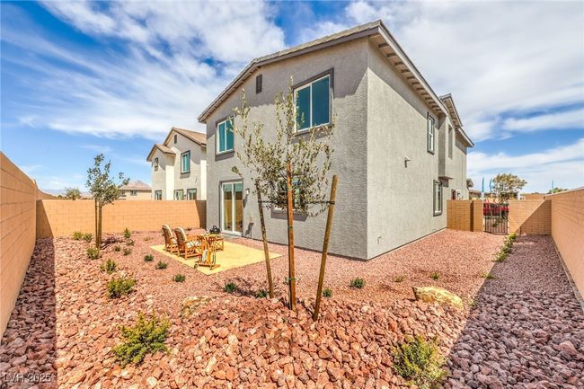 Photo is representational only; actual home finishes may vary. Rear view of property featuring a gate, a fenced backyard, a patio area, and stucco siding | Image 43